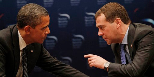 March 26, 2012: President Obama chats with Russian President Dmitry Medvedev during a bilateral meeting at the Nuclear Security Summit in Seoul, South Korea.