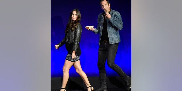 Megan Fox, left, and Will Arnett, cast members in the upcoming film "Teenage Mutant Ninja Turtles: Out of the Shadows," take the stage during the Paramount Pictures presentation at CinemaCon 2016, the official convention of the National Association of Theatre Owners (NATO), at Caesars Palace on Monday, April 11, 2016, in Las Vegas, NV.