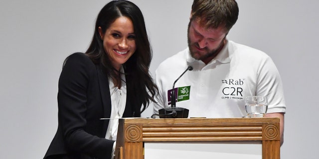 Meghan Markle gives a smile during an awkward moment while helping to present awards at the annual Endeavour Found Awards gala in London.