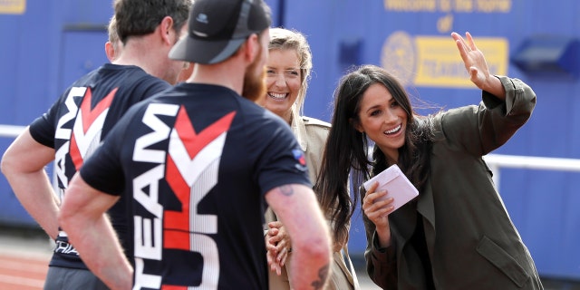 Markle meets with athletes on the track at the Invictus trials in Bath, England.