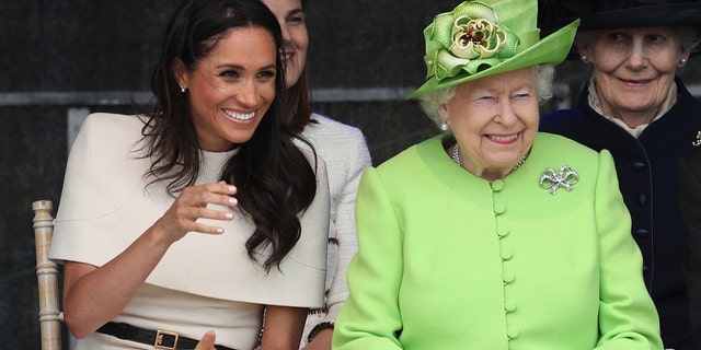 Britain's Queen Elizabeth II and Meghan, the Duchess of Sussex, left, attend the opening of the new Mersey Gateway Bridge, in Widnes, north west England, Thursday June 14, 2018. (Danny Lawson/PA via AP)
