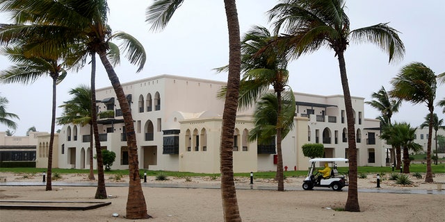 May 25, 2018: A club car passes the trees at a hotel in Salalah, Oman, as winds pick up.
