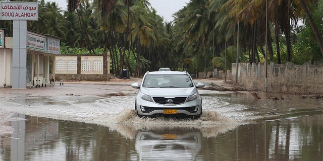 May 25, 2018: A car makes its way through standing water on a road in Salalah, Oman.