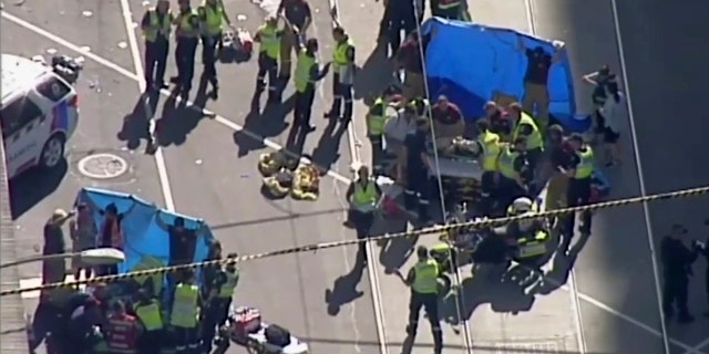 In this photo made from Australian Broadcasting Corp. video, medical workers offer aid to victims in Melbourne, Australia, Dec. 21, 2017.