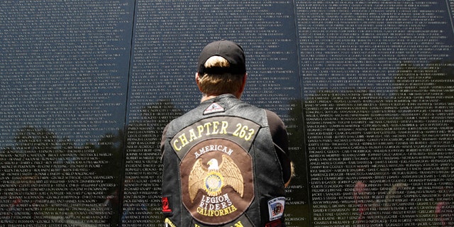 May 26, 2013: A veteran looks at the names of those who died etched into the wall of the Vietnam Veterans Memorial, ahead of Memorial Day in Washington, Sunday.