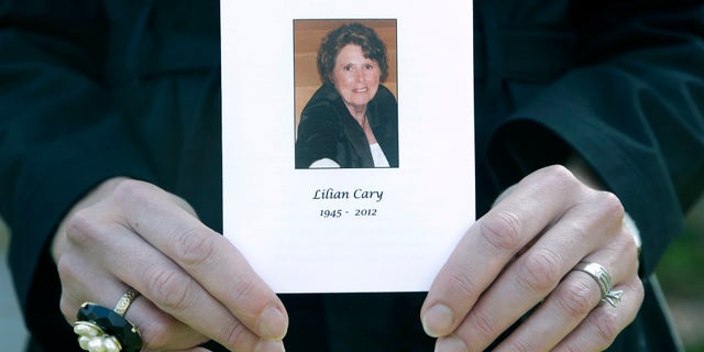 Jill Bloser, 43, of Charleston, S.C., holds a photo of her mother Lilian Cary. George Cary, whose wife's death was linked to the national outbreak of fungal meningitis said that he, too, was treated with steroids that may have been contaminated. (AP Photo/Paul Sancya, File)