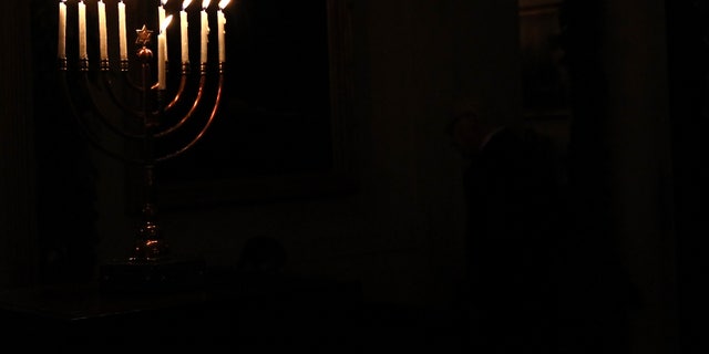 WASHINGTON, DC - DECEMBER 08: (AFP OUT) A menorah burns in the White House after U.S. President Barack Obama delivered remarks during a Hanukkah reception December 8, 2011 in Washington, DC. The reception helped recognize and celebrate the Jewish tradition also known as the Festival of Lights. (Photo by Win McNamee/Getty Images)