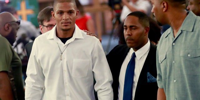 In this June 7, 2018, file photo, Robert Johnson, 35, left, leaves after his statement at New Beginnings Christian Church in Mesa, Ariz.