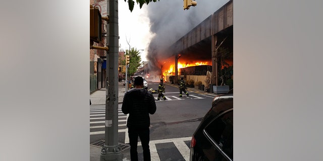 May 17, 2016: Firefighters battle a fire under the Metro-North railroad tracks in New York.