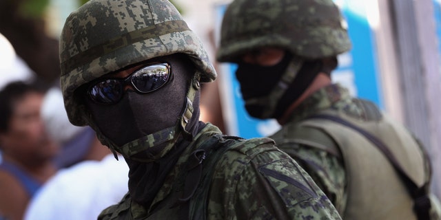 ACAPULCO, MEXICO - FEBRUARY 29:  Mexican army soldiers stand guard at the site of a suspected drug execution on February 29, 2012 in Acapulco, Mexico. Drug violence surged in the coastal resort last year, making Acapulco the second most deadly city in Mexico after Juarez. One of the country's top tourist destinations, Acapulco has suffered a drop in business, especially from foreign tourists. Toursim accounts for some 9 percent of Mexico's economy and about 70 percent of the output of Acapulco's state of Guerrero.  (Photo by John Moore/Getty Images)