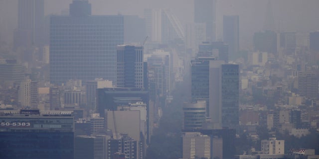 March 16, 2016: Buildings stand shrouded in smog in Mexico City.
