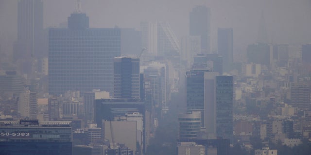 March 16, 2016: Buildings stand shrouded in smog in Mexico City.