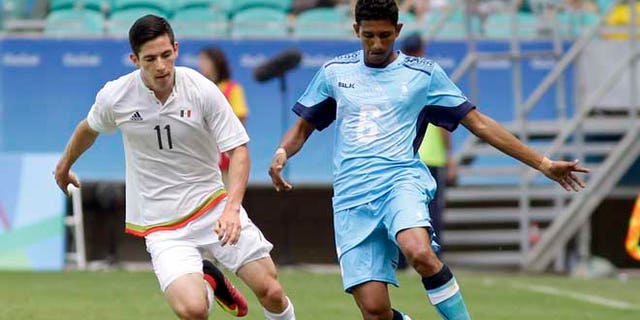 Mexico's Marco Bueno, left, fights for the ball with Fiji's Anish Khem during a group C match of the men's Olympic football tournament between Mexico and Fiji at the Fonte Nova Arena in Salvador, Brazil, Sunday, Aug. 7, 2016. (AP Photo/Arisson Marinho)