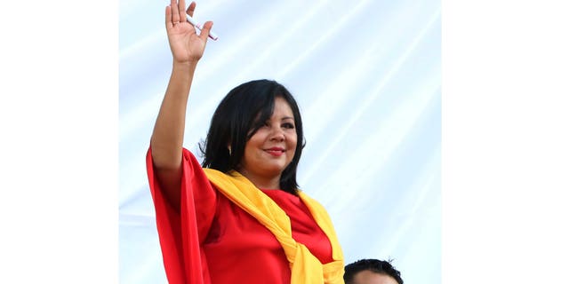 In this Friday, Jan. 1, 2016 photo, Gisela Mota waves during her swearing in ceremony as mayor of Temixco, Morelos State, Mexico. The Morelos state Public Security Commission says attackers invaded Mota's house on Saturday morning and killed her. (AP Photo/Tony Rivera)