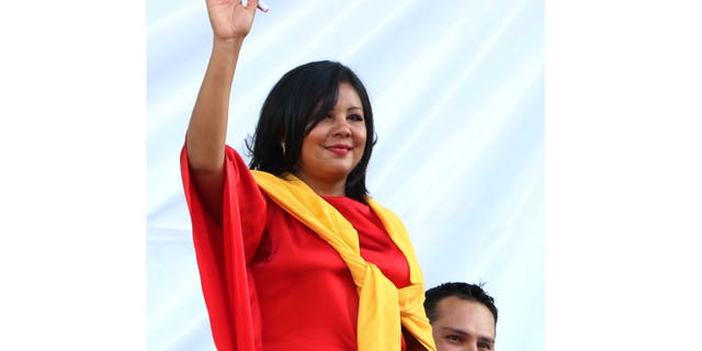 In this Friday, Jan. 1, 2016 photo, Gisela Mota waves during her swearing in ceremony as mayor of Temixco, Morelos State, Mexico. The Morelos state Public Security Commission says attackers invaded Mota's house on Saturday morning and killed her. (AP Photo/Tony Rivera)