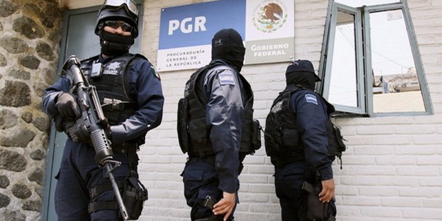 May 19: Federal police stand guard outside the Attorney General's office (PGR) in Cuernavaca after the arrest of Victor Valdez, known as "El Gordo Varilla" (The Big Stick).