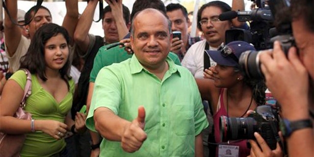 Jan. 30, 2011: Candidate for state governor Manuel Anorve, of the Institutional Revolutionary Party, PRI, center, gestures as he poses for photos after casting his vote in Acapulco, Mexico. Corruption scandals, political violence and the drug war shadow Sunday's gubernatorial election in the Pacific coast state of Guerrero, home to the resort city of Acapulco and a cartel battleground.