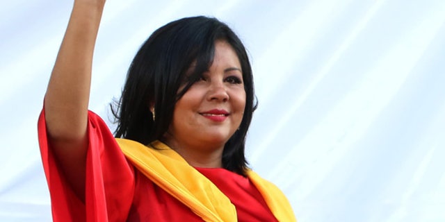 In this Friday, Jan. 1, 2016 photo, Gisela Mota waves during her swearing in ceremony as mayor of Temixco, Morelos State, Mexico. The Morelos state Public Security Commission says attackers invaded Mota's house on Saturday morning and killed her. (AP Photo/Tony Rivera)