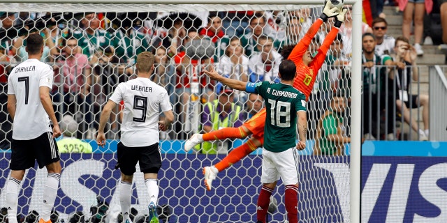 Mexico goalkeeper Guillermo Ochoa, right, jumps for the ball during the group F match between Germany and Mexico at the 2018 soccer World Cup in the Luzhniki Stadium in Moscow, Russia, Sunday, June 17, 2018.