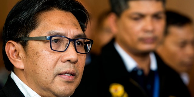 April 2, 2014: Malaysia's civil aviation chief Azharuddin Abdul Rahman, left, is accompanied by an unidentified Malaysia Airlines official while answering questions during a press conference after a close door meeting with Chinese relatives of the passengers onboard the missing Malaysia Airlines Flight 370 at a hotel in Bangi, on the outskirts of Kuala Lumpur, Malaysia.