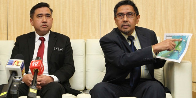 Director general of the Malaysian Department of Civil Aviation, Azharuddin Abdul Rahman, right, shows the search area map during a press conference as Malaysia new Transport Minister Anthony Loke Siew Fook looks on in Putrajaya, Malaysia on Wednesday, May 23, 2018.