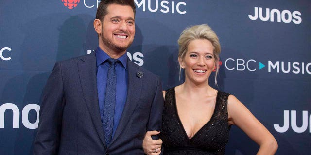FILE - In this March 25, 2018 file photo, Michael Buble and his wife Luisana Lopilato at the Juno Awards in Vancouver, British Columbia. Buble and Lopilato are the proud parents of a baby girl. Buble's representative says that Vida Amber Betty was born Wednesday in Vancouver. She is 6 pounds, 1 ounce. Buble and Lopilato also have two sons, Elias and Noah. Lopilato, an Argentine TV actress, posted a photo of her baby girl's hand Thursday on Instagram.