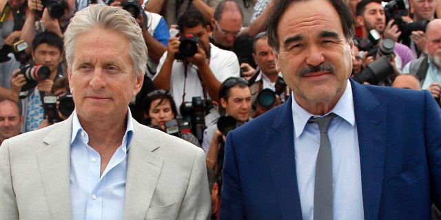 Michael Douglas, left, poses with director Oliver Stone during a photocall for "Wall Street - Money Never Sleeps."