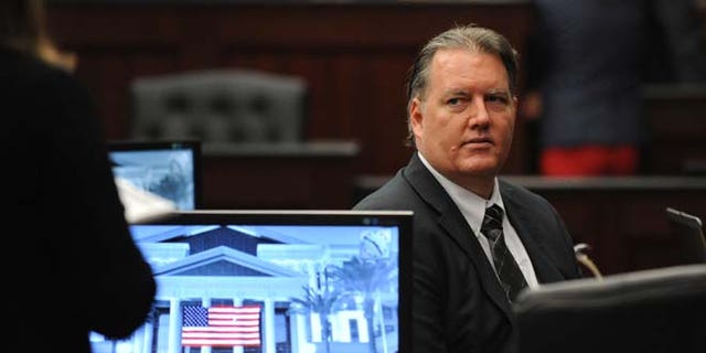 Sept. 27, 2014: Michael Dunn looks towards the legal representative sitting with his parents as his trial ends for the day in the Duval County Courthouse in Jacksonville, Fla.