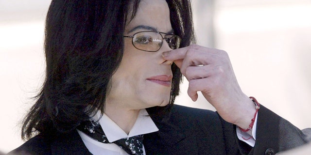 April 12, 2005: Michael Jackson touches his nose as he departs the Santa Barbara County courthouse in Santa Maria, Calif.