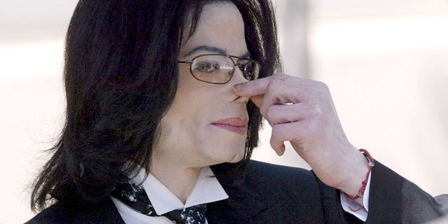 April 12, 2005: Michael Jackson touches his nose as he departs the Santa Barbara County courthouse in Santa Maria, Calif.