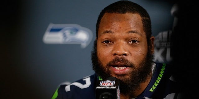 Defensive end Michael Bennett, then with the Seattle Seahawks, speaks during a Super Bowl 49 media availability in Arizona in 2015