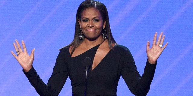 FILE - In this July 12, 2017, file photo, former first lady Michelle Obama presents the Arthur Ashe Courage Award at the ESPYS at the Microsoft Theater in Los Angeles.