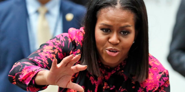 FILE - In this Dec. 12, 2016, file photo, first lady Michelle Obama waves as she departs after a holiday event at Children's National Health System in Washington.