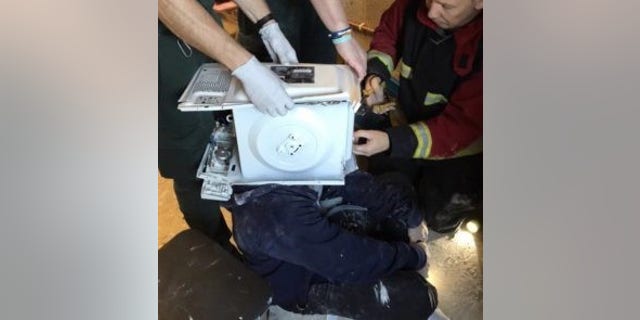 Firefighters were called to rescue a man who had cemented a microwave oven on his head in a YouTube stunt. (© West Midlands Fire Service)