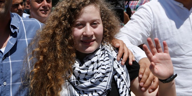Ahed Tamimi waves after she visited the tomb of former Palestinian leader Yasser Arafat in the West Bank city of Ramallah.