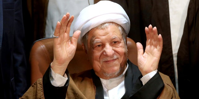 FILE -- Former Iranian President Akbar Hashemi Rafsanjani waves to journalists as he registers his candidacy for the elections of the Experts Assembly, in Tehran, Iran.