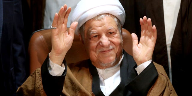 FILE -- Former Iranian President Akbar Hashemi Rafsanjani waves to journalists as he registers his candidacy for the elections of the Experts Assembly, in Tehran, Iran.