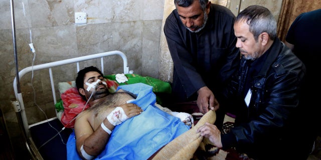 Feb. 29, 2016: An injured victim of bombing attacks receives treatment at the Imam Ali Hospital in Sadr City, Baghdad, Iraq. (AP Photo/Karim Kadim)