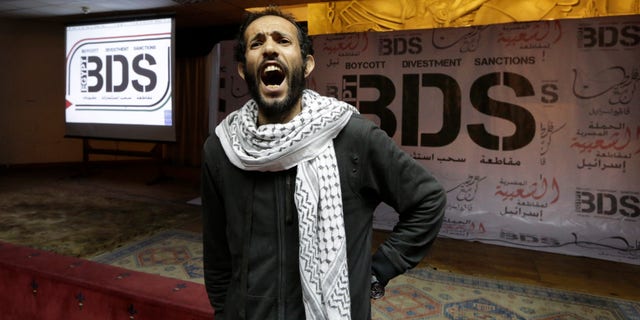 Apr. 20, 2015: Egyptian man shouts anti-Israeli slogans in front of banners with the Boycott, Divestment and Sanctions (BDS) logo during the launch of the Egyptian campaign that urges boycott, divestment and sanctions against Israel and Israeli-made goods. (AP)