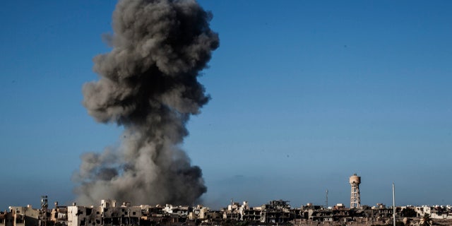 Sept. 28, 2016: Smoke rises after an airstrike on an ISIS-held area of Sirte, Libya.