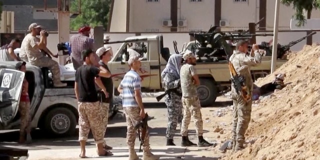 FILE -- June 14, 2016: This image made from Associated Press video shows Armed Misrata fighters loyal to the unity government on the main street of Sirte. A Libyan hospital spokesman says many pro-government fighters have been killed and tens wounded in latest fighting for the Islamic State group's bastion of Sirte. Libyan forces loyal to the unity government have been waging an offensive since last month to dislodge the militants from the coastal city.