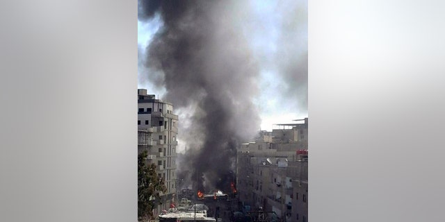 Smoke rises in Damascus after a triple bombing.