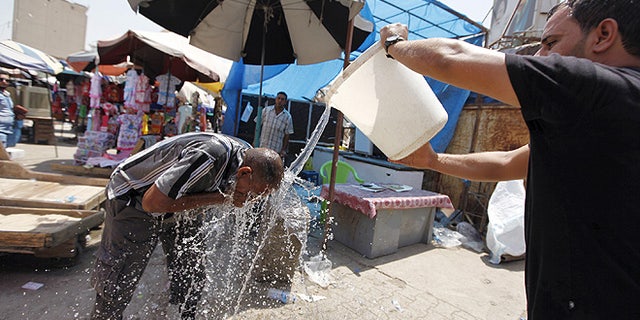 A man cools off during the heat wave in Baghdad. (REUTERS/Ahmed Saad)