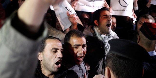 Mar. 10, 2014: Jordanian protesters shout slogans across the street from the Israeli embassy and demand the deportation of the Israeli ambassador after the killing of Jordanian judge Raed Zueter, 38, at Allenby crossing between Jordan and the West Bank, in Amman, Jordan.