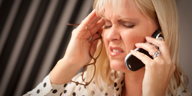 Blonde Woman on Her Cell Phone with Stressed Look on Her Face.
