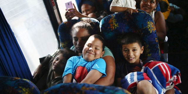 Central American migrants, moving in a caravan through Mexico, smile as they travel to Hermosillo in a new route of his travel, in Mazatlan, in Sinaloa state, Mexico, April 21, 2018.
