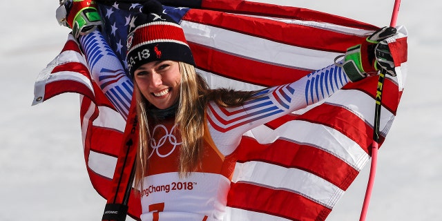 Mikaela Shiffrin celebrates her gold medal after placing first in the women's giant slalom at the 2018 Winter Olympics.
