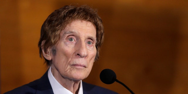 FILE- In a file photo from Nov. 14, 2014, Detroit Tigers owner Mike Ilitch listens during a news conference in Detroit. Ilitch, the owner of the Detroit Red Wings and Tigers, who founded the Little Caesars Pizza empire, has died.