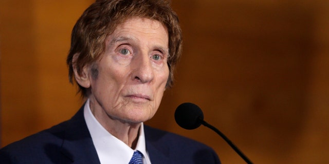 FILE- In a file photo from Nov. 14, 2014, Detroit Tigers owner Mike Ilitch listens during a news conference in Detroit. Ilitch, the owner of the Detroit Red Wings and Tigers, who founded the Little Caesars Pizza empire, has died.