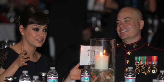 Sgt. Scott Moore and his guest, actress Mila Kunis attend the 236th Marine Corps birthday ball for 3rd Battalion, 2nd Marine Regiment, 2nd Marine Division in Greenville, N.C., Nov. 18, 2011.